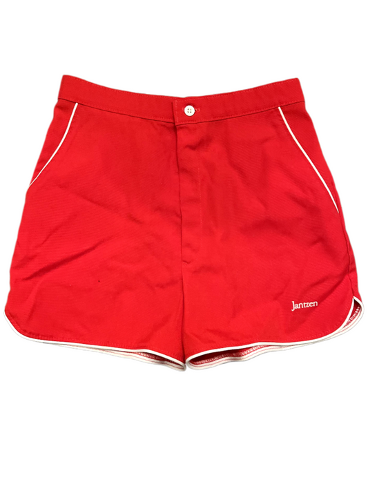 Front of vintage red shorts with white stripe on white background.