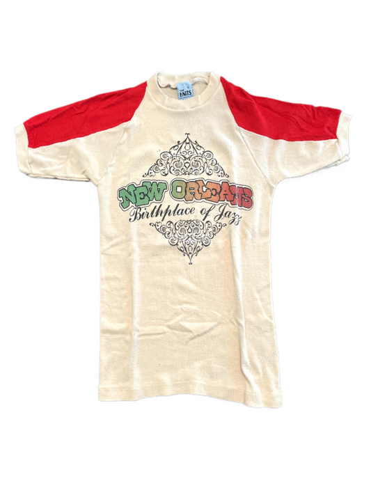 Vintage red and cream New Orleans birthplace of jazz tee on white background.