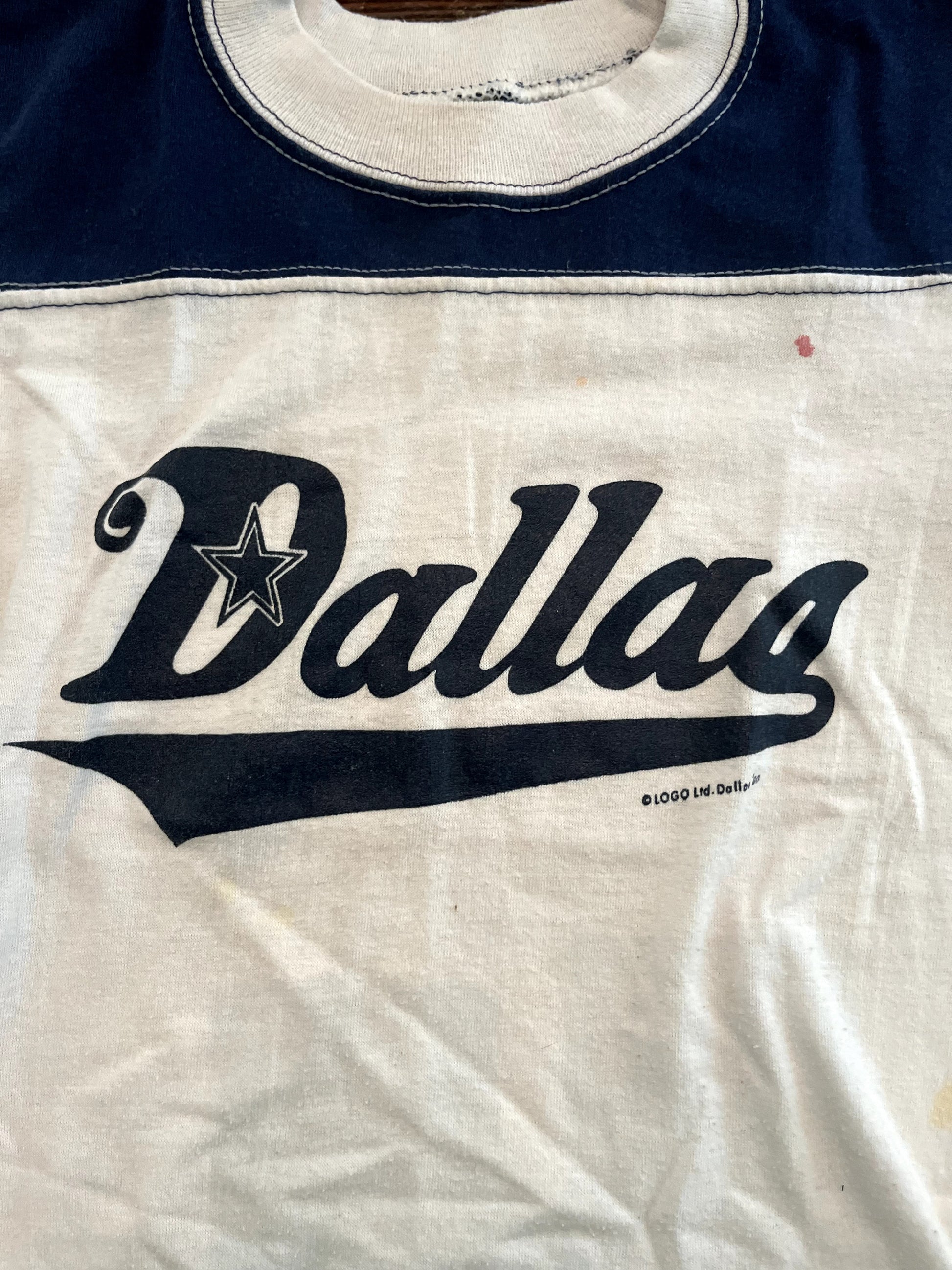 Image of vintage youth navy blue and white dallas cowboys tee on white background close up of graphic.