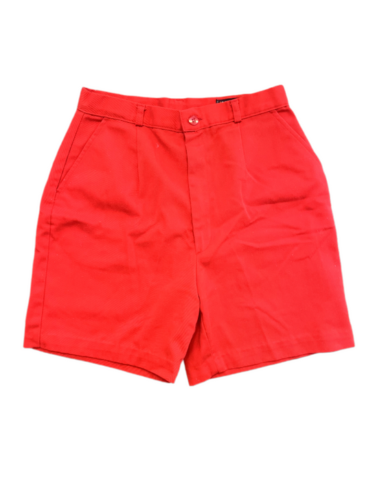 Vintage red ladies shorts with button, zipper and pockets on white background.