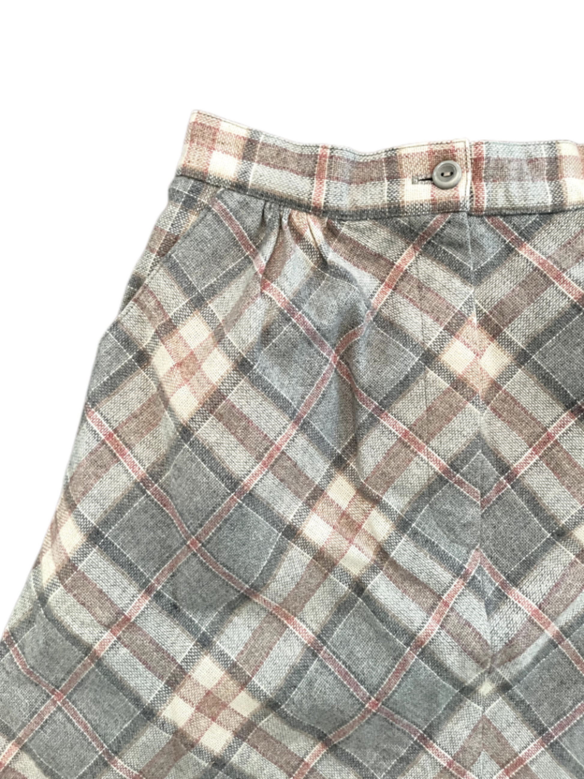 Vintage ladies 7/8ths plaid skirt in pink, grey and white with front zipper and button on white background close up image of pockets and button.