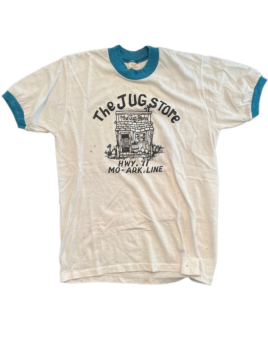 Vintage Jug Store tee shirt on white and blue ringer on white background.